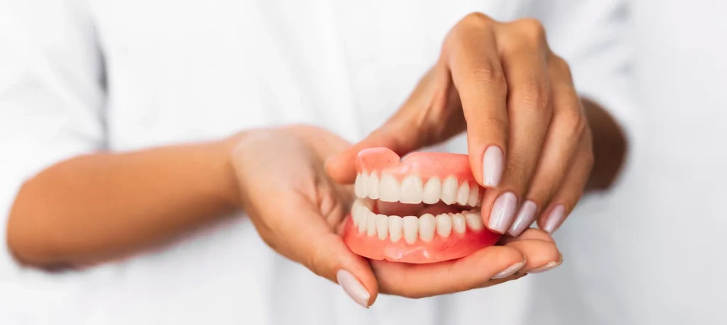 dentist holding full affordable dentures naples