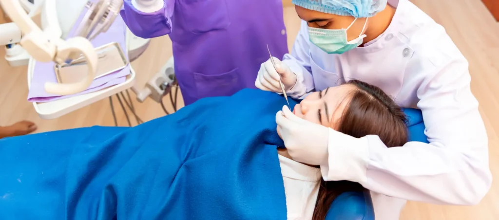 dentist checking if denture needs denture repairs naples