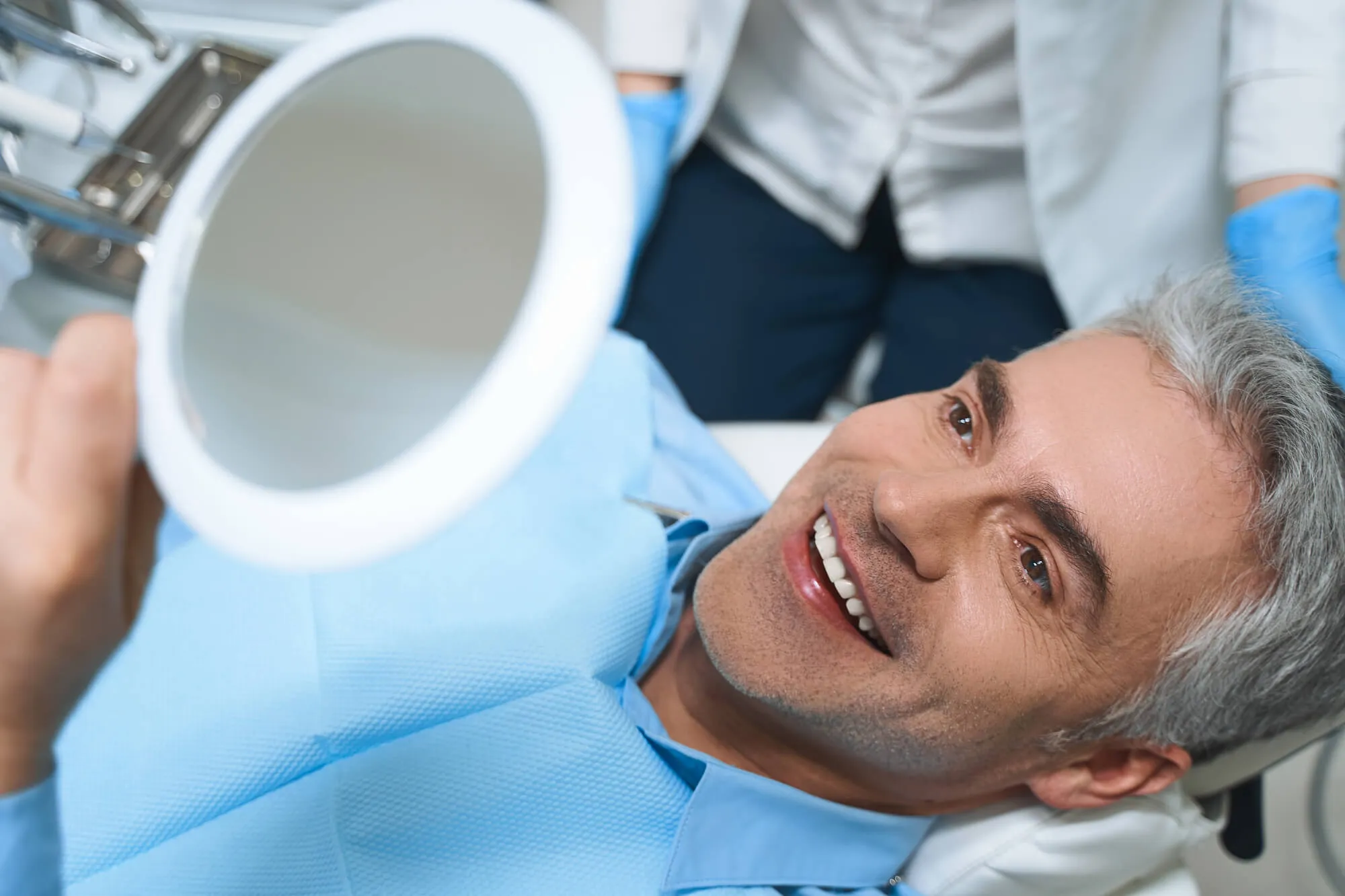 senior patient loving his new dental implants naples